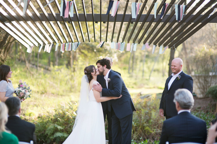 bride and groom first kiss