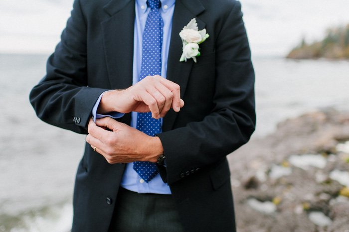 groom adjusting cuffs