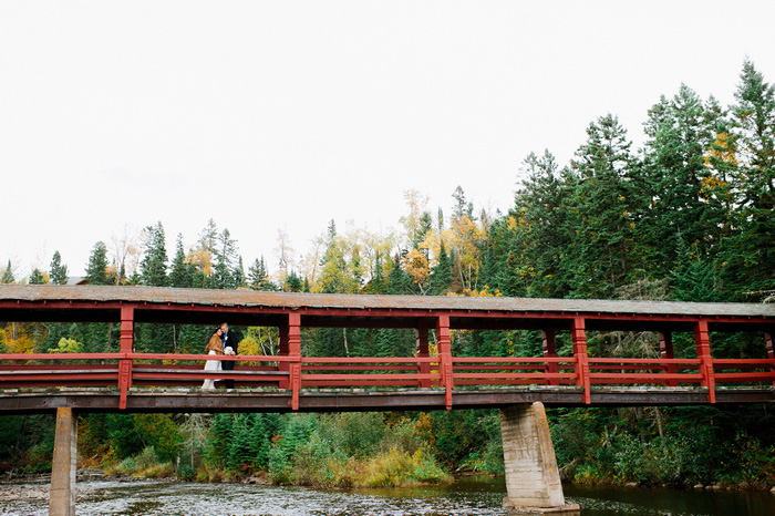 bride and groom portrait on covered bridge 