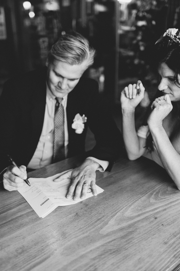 groom signing marriage certificate