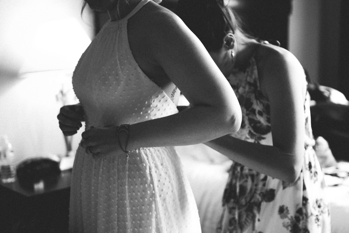 bride's dress being tied