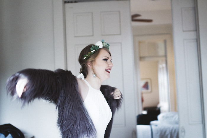 bride putting on faux fur coat