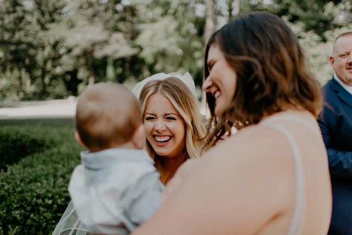 bride smiling at baby