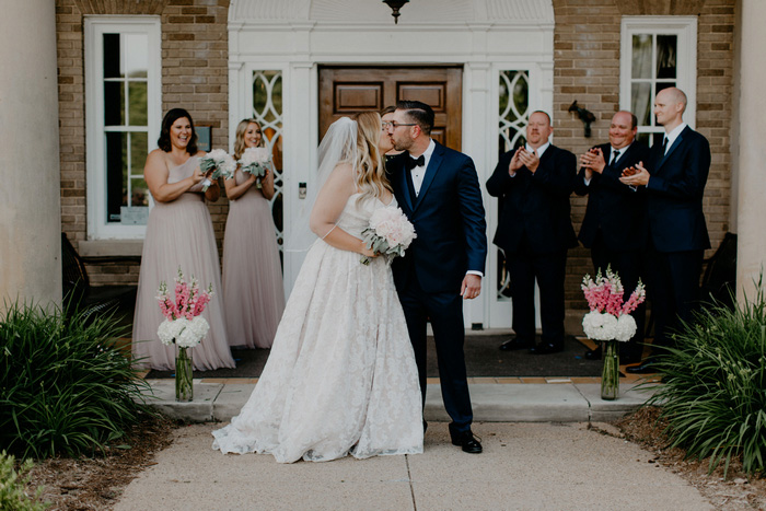 bride and groom first kiss