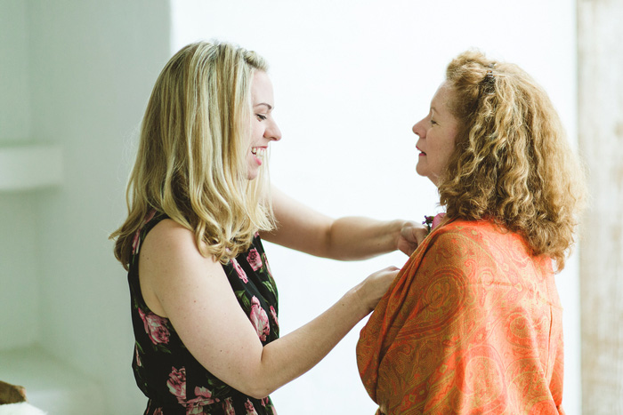 bride helping mother get ready