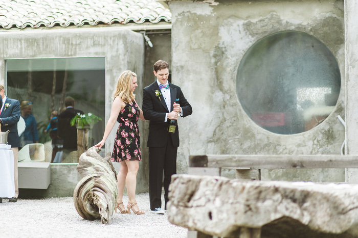 groom opening champagne bottle