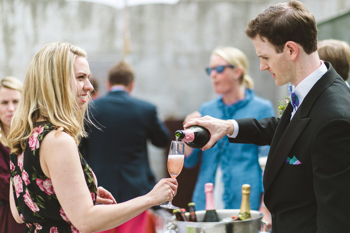 groom pouring bride champagne