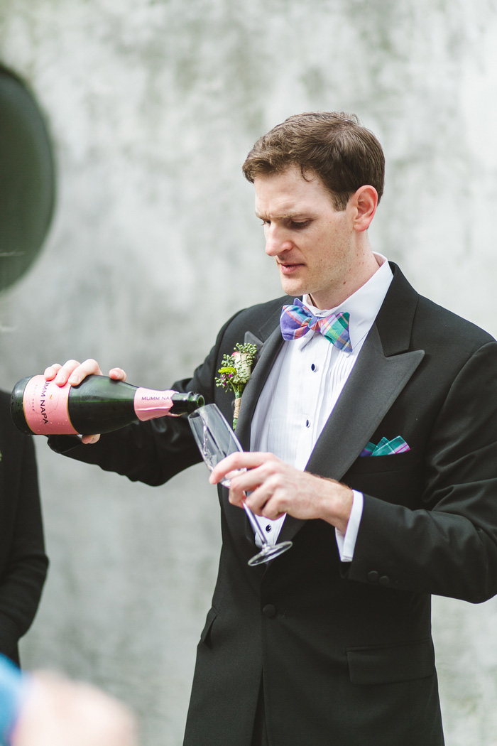 groom pouring champagne 
