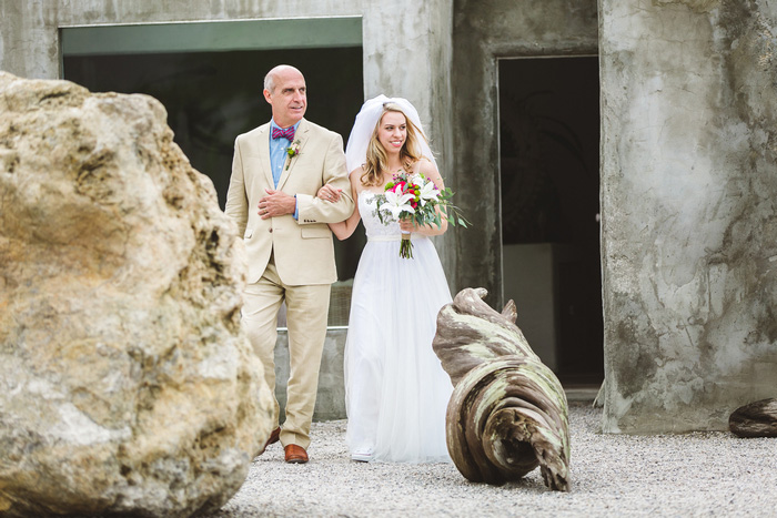 bride walking down aisle with father