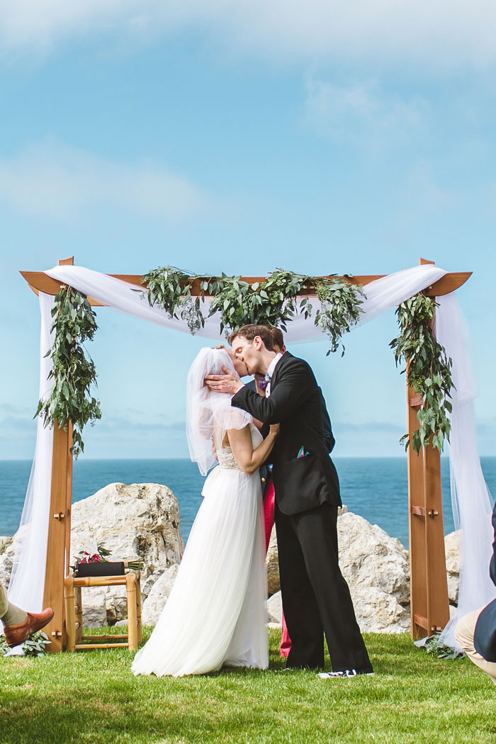 bride and groom first kiss