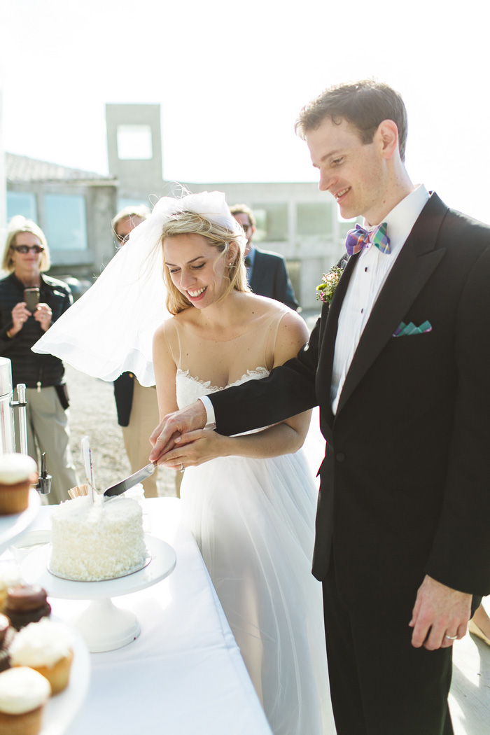 bride and groom cutting cake