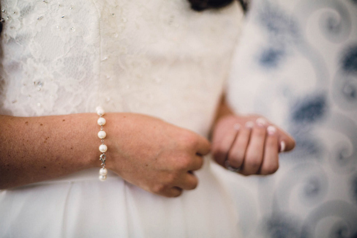 bride putting on bracelet 