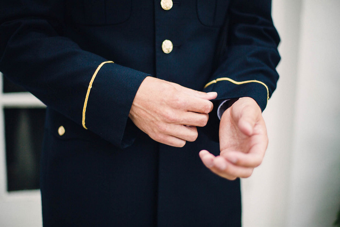 groom adjusting cuffs