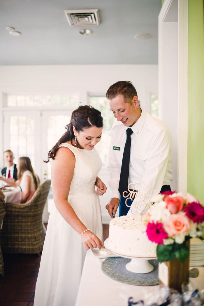 bride and groom cutting cake 