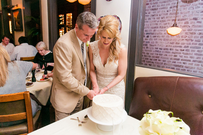 bride and groom cutting cake