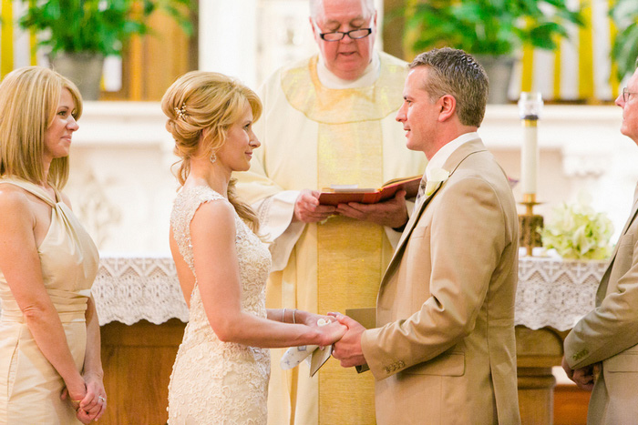 bride and groom facing each other at the altar