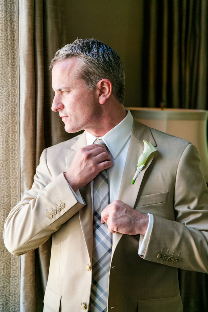 groom adjusting tie