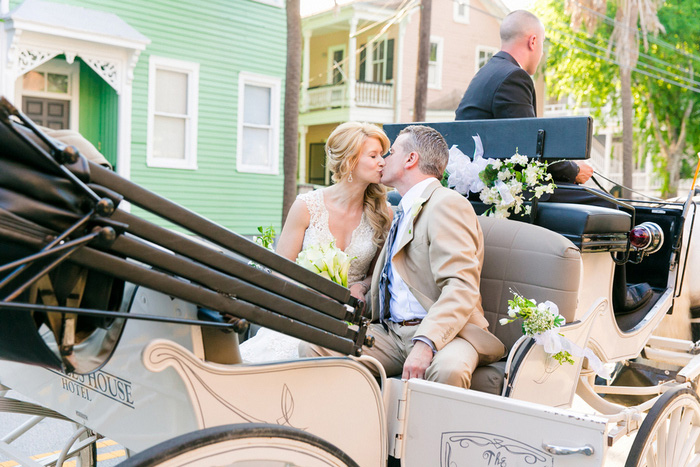 bride and groom kissing in carriage