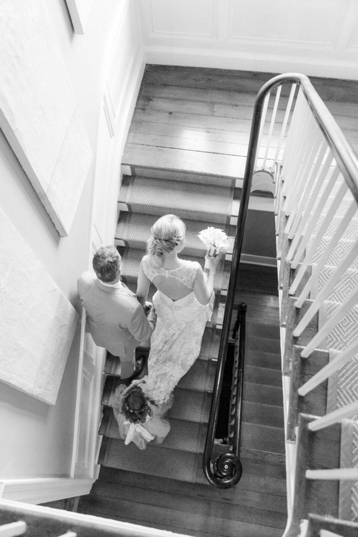 bird's eye view of bride and groom walking up stairs