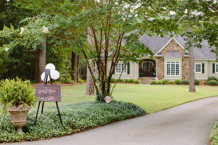 house with wedding welcome sign out front