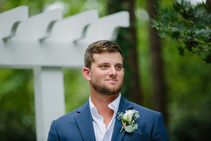 groom watching bride walk down the aisle