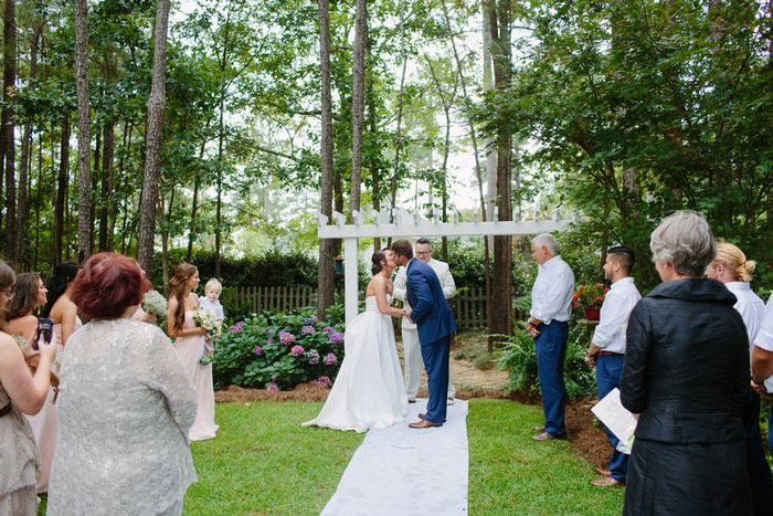 bride and groom first kiss