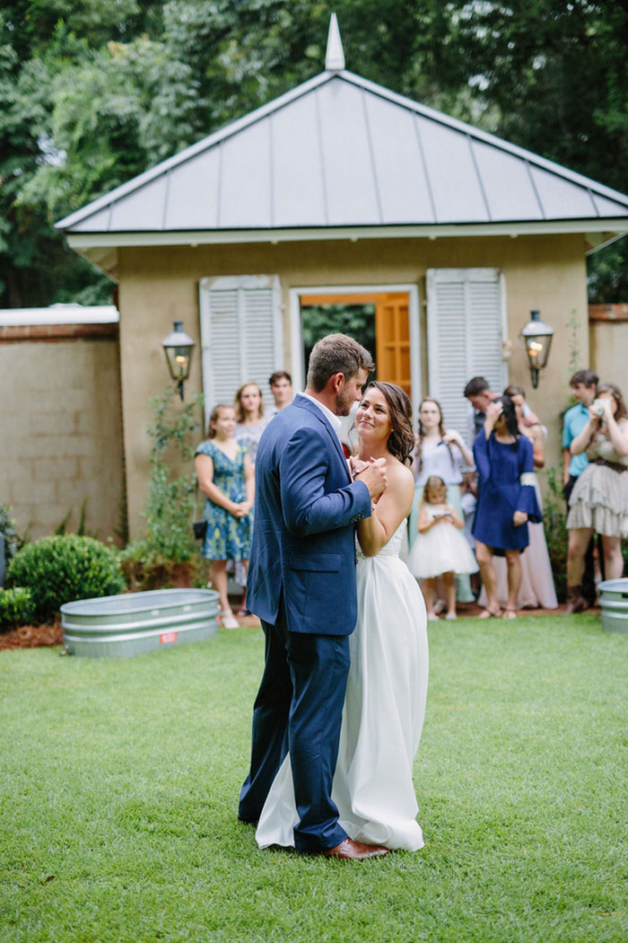 bride and groom dancing in backyard