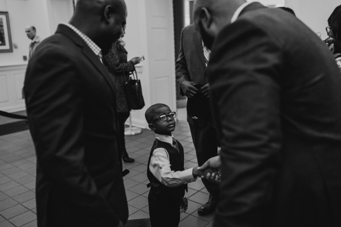 groom shaking hands with little boy