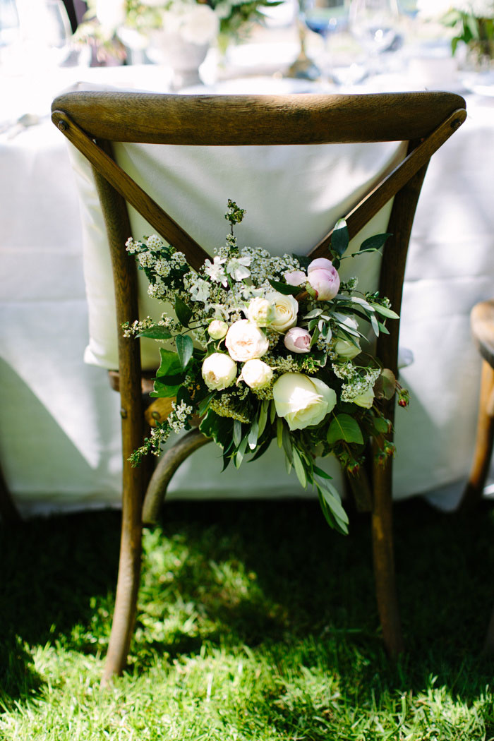 flowers on back of bride's chair