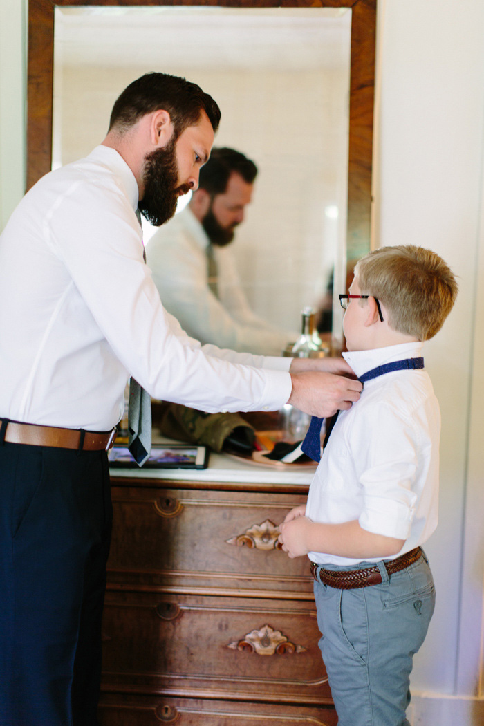 groom tying son's bow tie