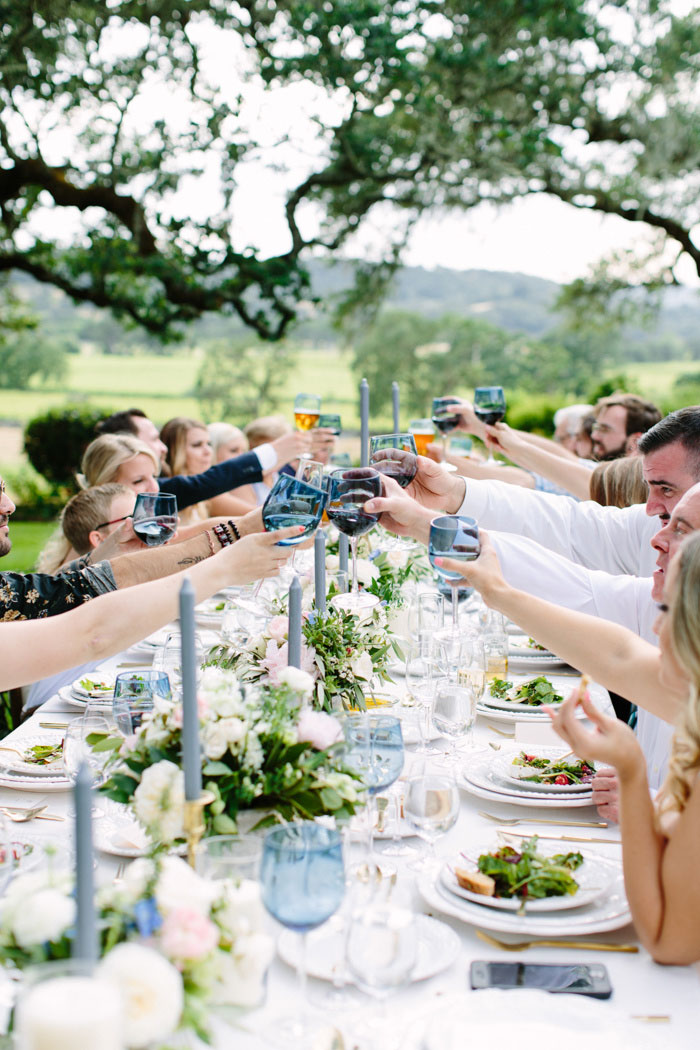 wedding guests raising glasses