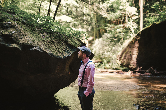 groom waiting by waterfall