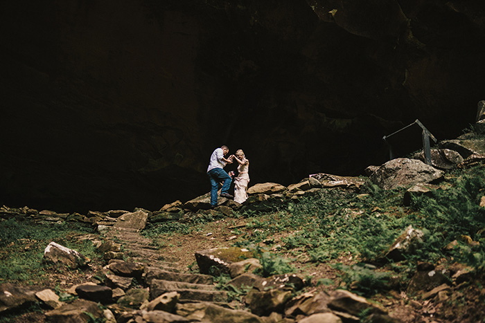 bride being helped down steep path