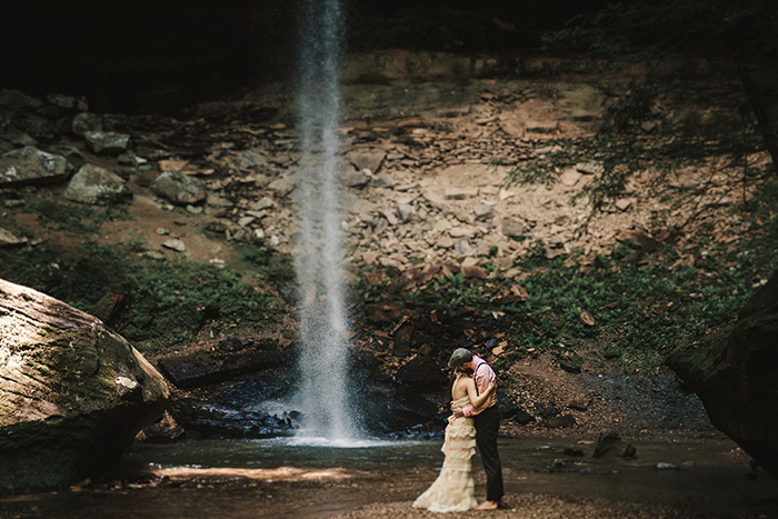 bride and groom portrait by waterfall