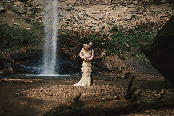 wedding portrait in front of waterfall 