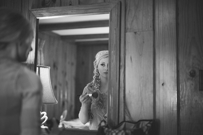 bride taking a photo in the mirror