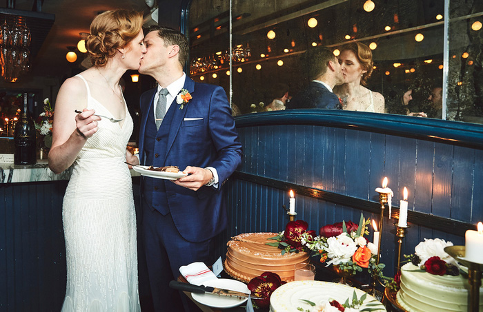 bride and groom kissing after cutting cake