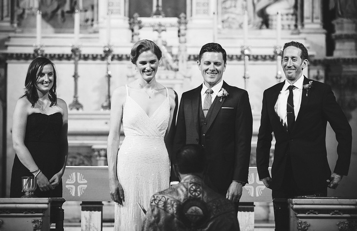 bride and groom facing guests at the altar