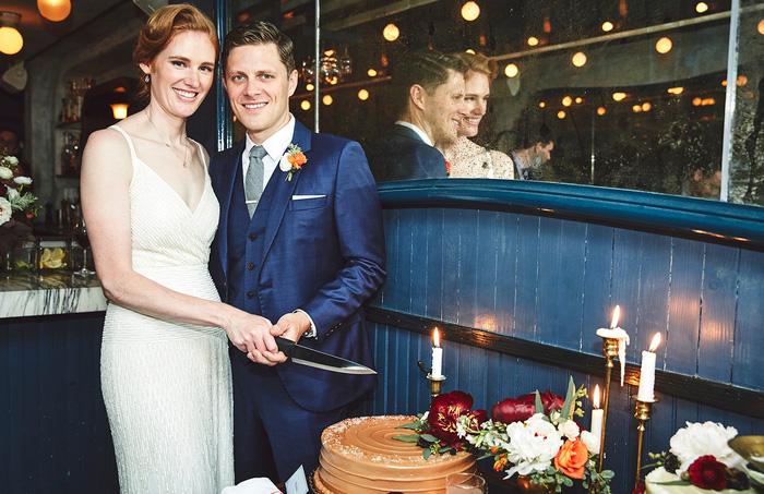 bride and groom about to cut cake