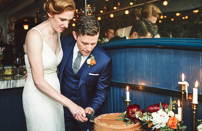 bride and groom cutting cake