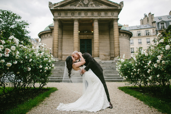 groom dipping bride and kissing her