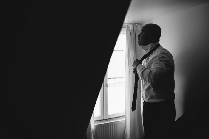 groom tying tie