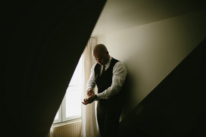 groom adjusting cuffs