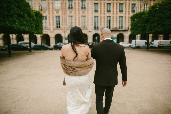 bride and groom walking through Paris