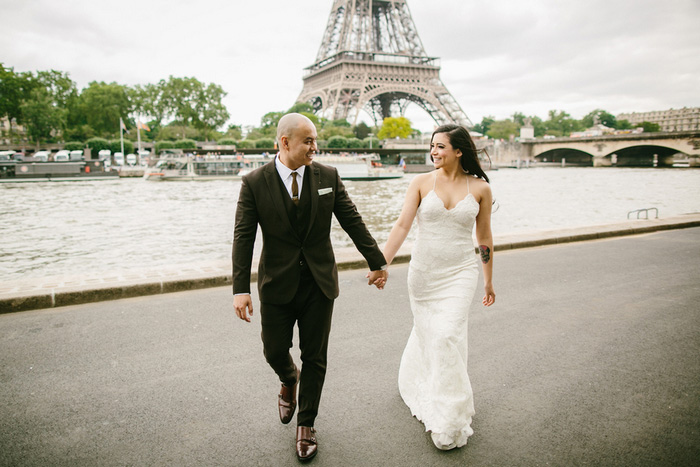 bride and groom walking away from Eiffel Tower