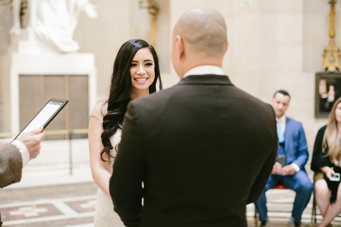 bride smiling at groom during ceremony