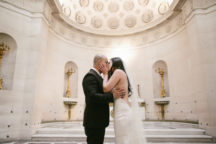 bride and groom first kiss