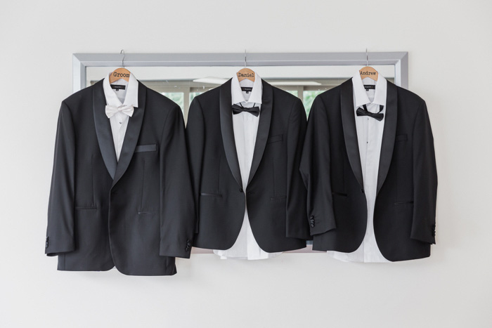 groomsmen's tuxedos hanging up