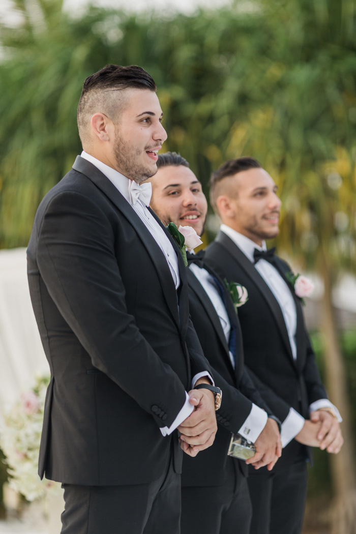 groom waiting at the altar