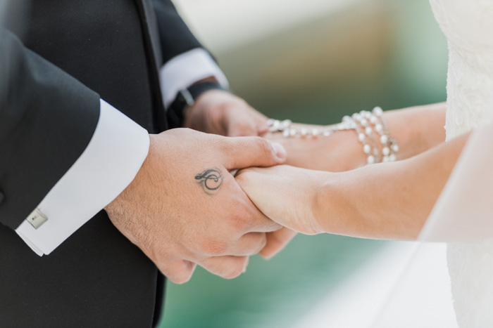 bride and groom holding hands during ceremony